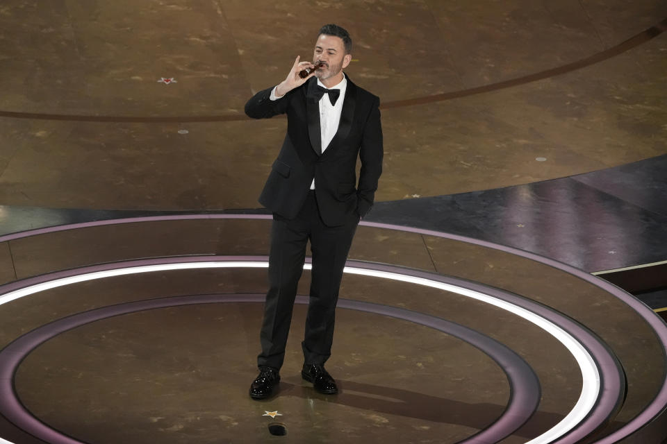 Jimmy Kimmel drinks a shot of tequila during the Oscars on Sunday, March 10, 2024, at the Dolby Theatre in Los Angeles. (AP Photo/Chris Pizzello)