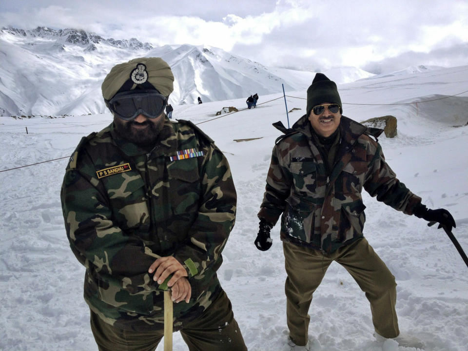 In this photo taken Sunday, Feb. 24, 2013, Indian Army soldiers stand on the top of Mount Affarwat at Gulmarg, Kashmir. Gulmarg, a ski resort nestled in the Himalayan mountains in Indian-held Kashmir, is one of the most militarized places on earth. (AP Photo/Kevin Frayer)