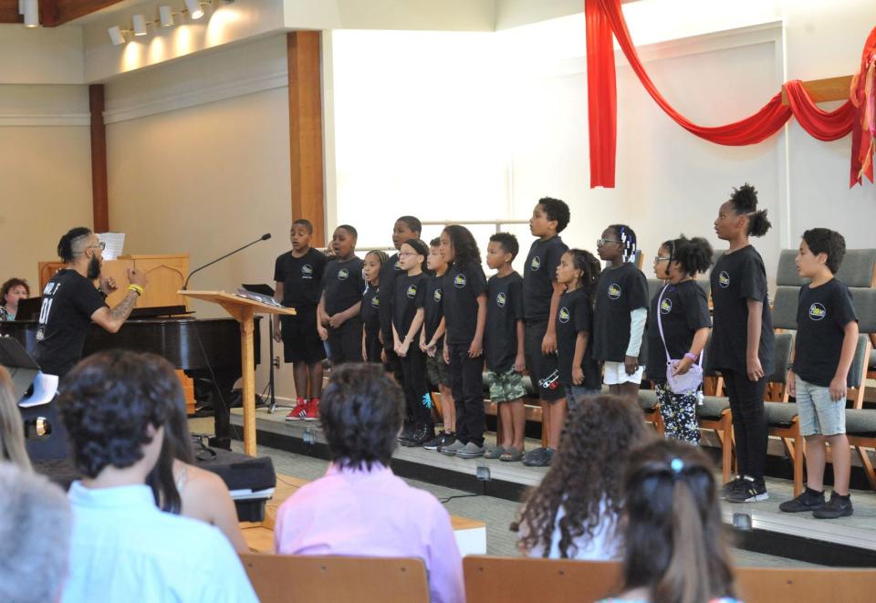 Students from the Rose Conservatory of Brockton perform under the direction of founder Greg Fernandes during the "Spring Ring" hand bell concert at the United Church of Christ in Norwell, Sunday, June 12, 2022.