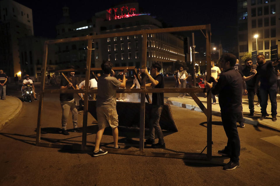 Anti-government protesters block a road during a protest against the political leadership they blame for the economic and financial crisis, in Beirut, Lebanon, Thursday, June 11, 2020. (AP Photo / Hussein Malla)