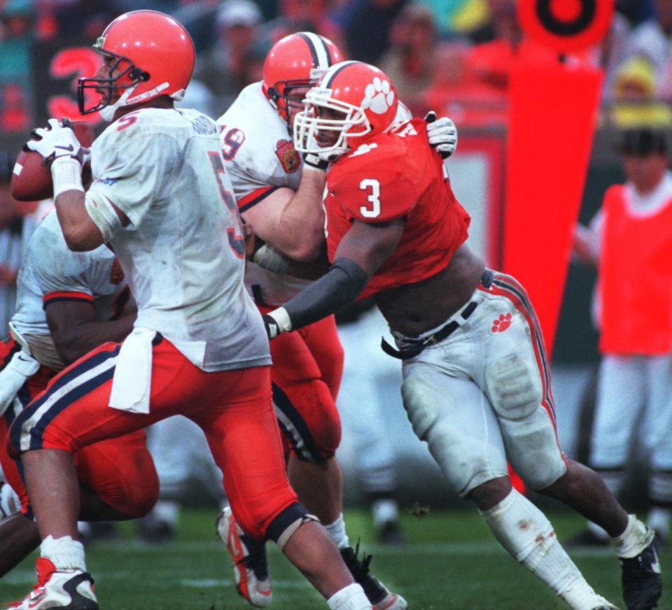 Syracuse quarterback Donovan McNabb tries to elude Clemson linebacker Patrick Sapp (3), a Raines graduate, during the 1996 Gator Bowl.