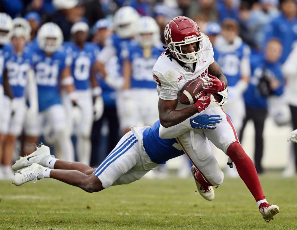 Brigham Young Cougars cornerback Kamden Garrett (7) tries to bring down Oklahoma Sooners wide receiver Jalil Farooq (3) as BYU and Oklahoma play at LaVell Edwards Stadium in Provo on Saturday, Nov. 18, 2023. | Scott G Winterton, Deseret News