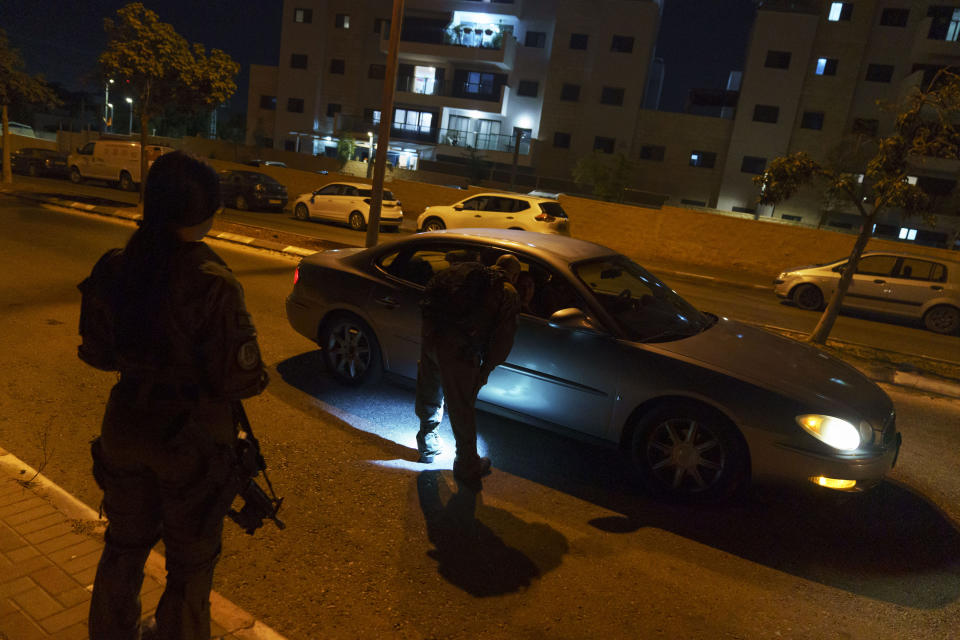 Police stop a car while patrolling a neighborhood in the Arab-Jewish town of Lod, central Israel, Friday, May 28, 2021, a week after a cease-fire went into effect in the 11-day war between Gaza's Hamas rulers and Israel. Lod and other mixed cities recently experienced ethnic clashes as groups of Arabs and Jews fought each other in the streets and torched cars, businesses and homes. (AP Photo/David Goldman)