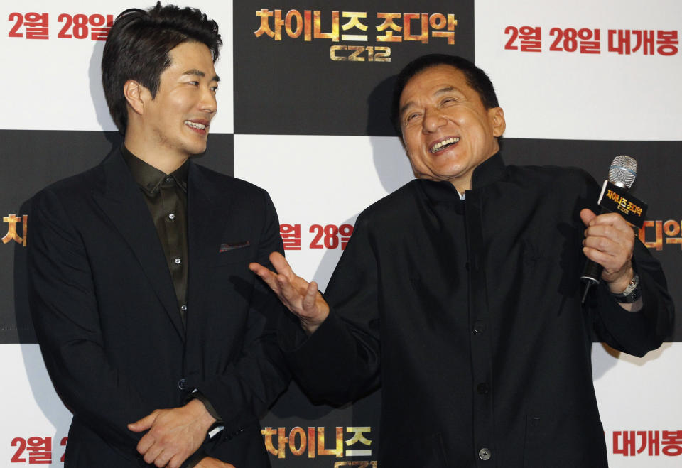CORRECTS YEAR - Hong Kong actor and director Jackie Chan, right, and South Korean actor Kwon Sang-woo smile during a promotional event for their latest movie, CZ12, or Chinese Zodiac, in Seoul, South Korea, Monday, Feb. 18, 2013. (AP Photo/Ahn Young-joon)