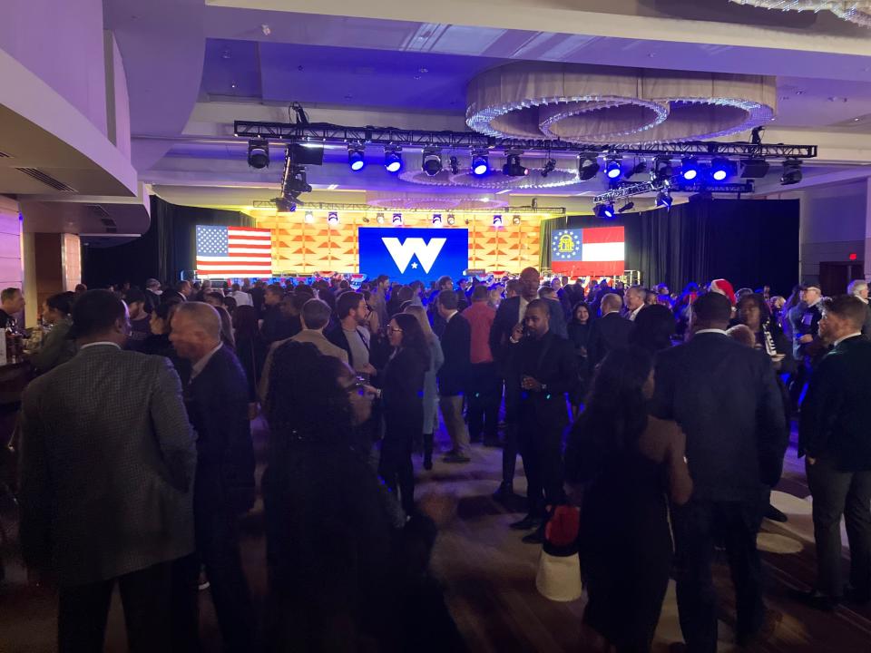 Sen. Raphael Warnock supporters arrive at his Election Night watch party at the Atlanta Marriott Marquis.