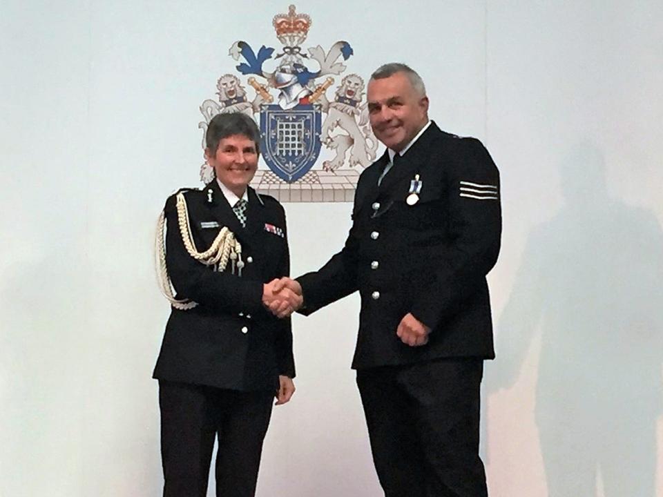 Sergeant Matt Ratana receives a service medal from commissioner Cressida DickPA