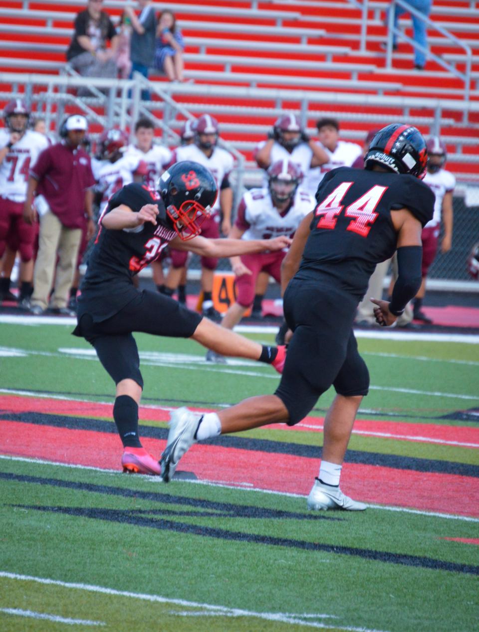 Jordan Hensley kicks off during a home football game against Newark last season.