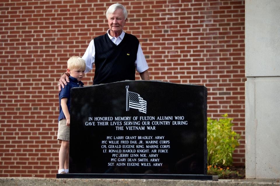 1968 Fulton High School graduate Fred Kitts and grandson Cannon Cates stand by the veterans memorial honoring the seven Fulton students who were killed in the Vietnam War. 