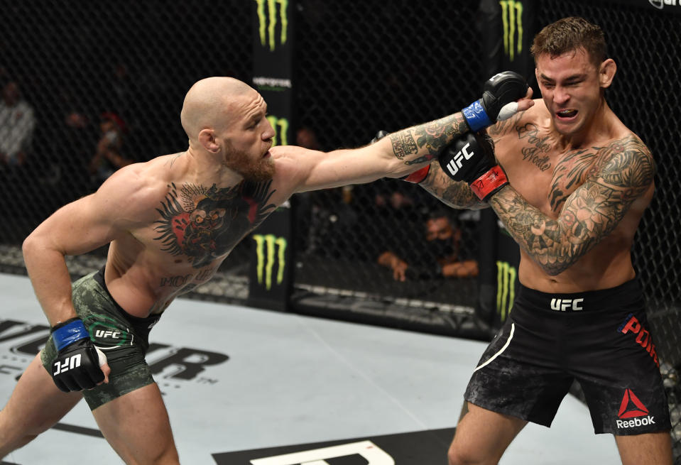 ABU DHABI, UNITED ARAB EMIRATES - JANUARY 23: (L-R) Conor McGregor of Ireland punches Dustin Poirier in a lightweight fight during the UFC 257 event inside Etihad Arena on UFC Fight Island on January 23, 2021 in Abu Dhabi, United Arab Emirates. (Photo by Jeff Bottari/Zuffa LLC)