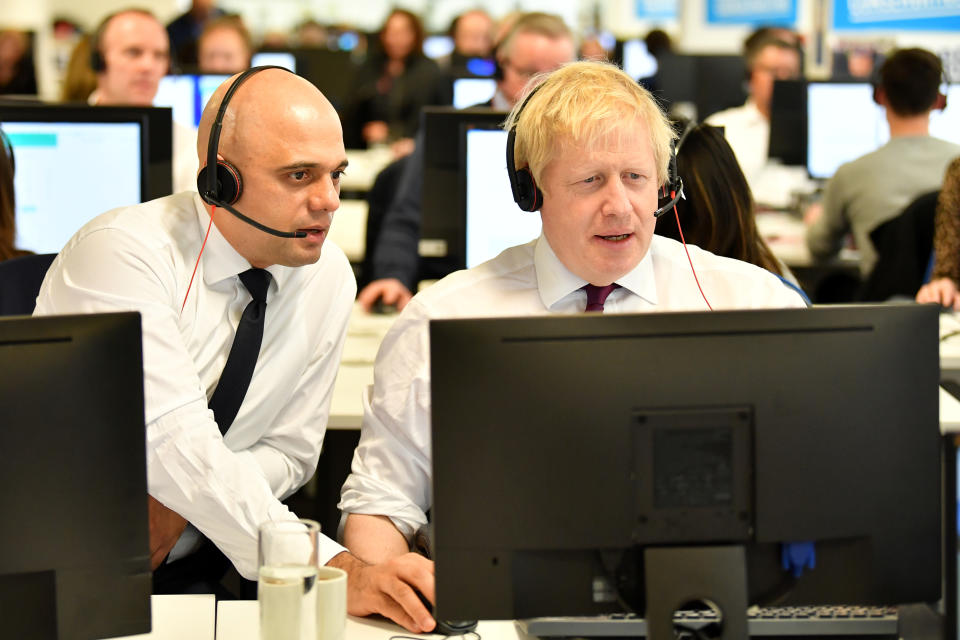Britain's Chancellor of the Exchequer Sajid Javid and Britain's Prime Minister Boris Johnson speak to callers at the Conservative Campaign Headquarters Call Centre in central London, Britain, December 8, 2019. Ben Stansall/Pool via REUTERS