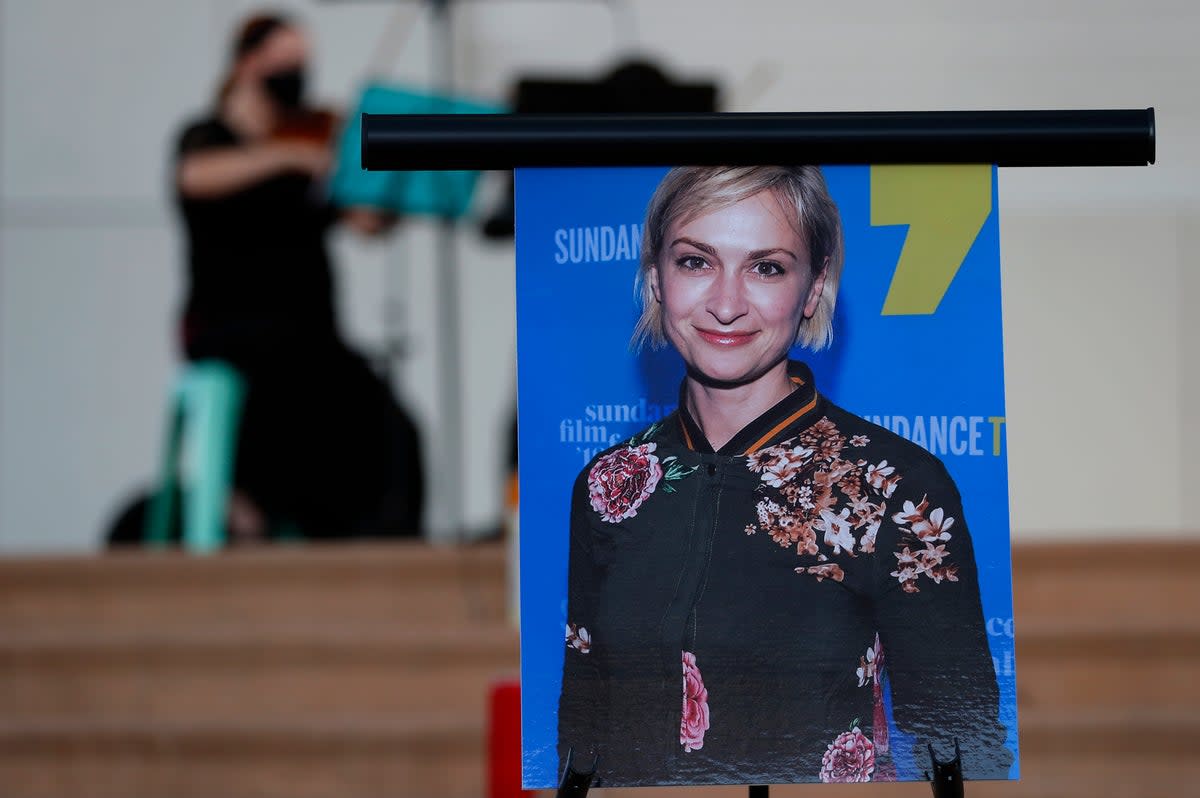 A musician plays a violin behind a photograph of cinematographer Halyna Hutchins during a vigil in her honor in Albuquerque, N.M (Copyright 2021 The Associated Press. All rights reserved.)