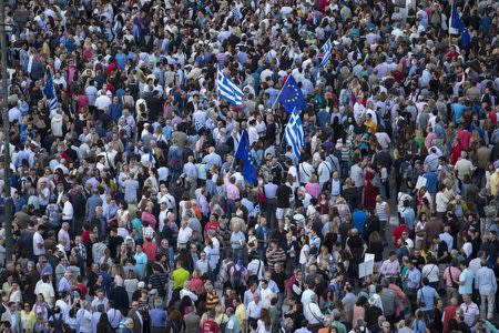 Protesters attend a rally in front of the parliament building, calling on the government to clinch a deal with its international creditors and secure Greece's future in the Eurozone, in Athens, Greece June 22, 2015. REUTERS/Marko Djurica