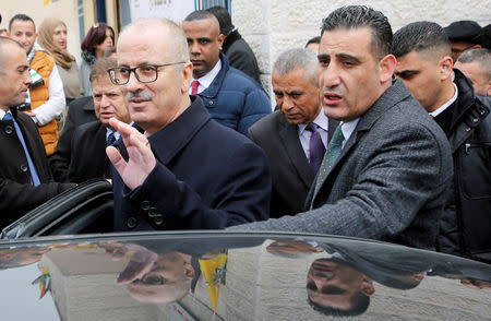 FILE PHOTO: Palestinian Prime Minister Rami Hamdallah waves as he leaves after attending the opening ceremony of a health center near Hebron, in the Israeli-occupied West Bank January 28, 2019. REUTERS/Mussa Qawasma/File Photo