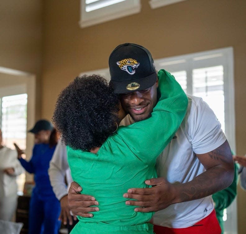 Jacksonville Jaguars defensive tackle Tyler Lacy gets a hug from mother Veronica right after the Jaguars drafted him in the fourth round last year.
