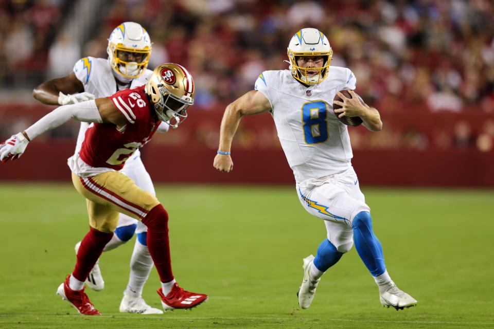 Los Angeles Chargers quarterback Max Duggan (8) runs with the ball past San Francisco 49ers cornerback Isaiah Oliver (26) during the third quarter at Levi's Stadium.