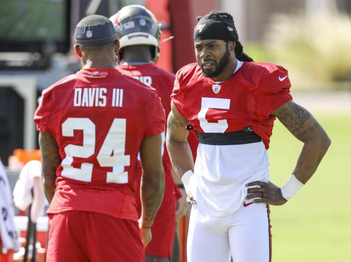 Tampa Bay Buccaneers' Richard Sherman, right, talks with teammate Carlton Davis III during an NFL football practice in Tampa, Fla., Wednesday, Sept. 29, 2021. (Chris Urso/Tampa Bay Times via AP)
