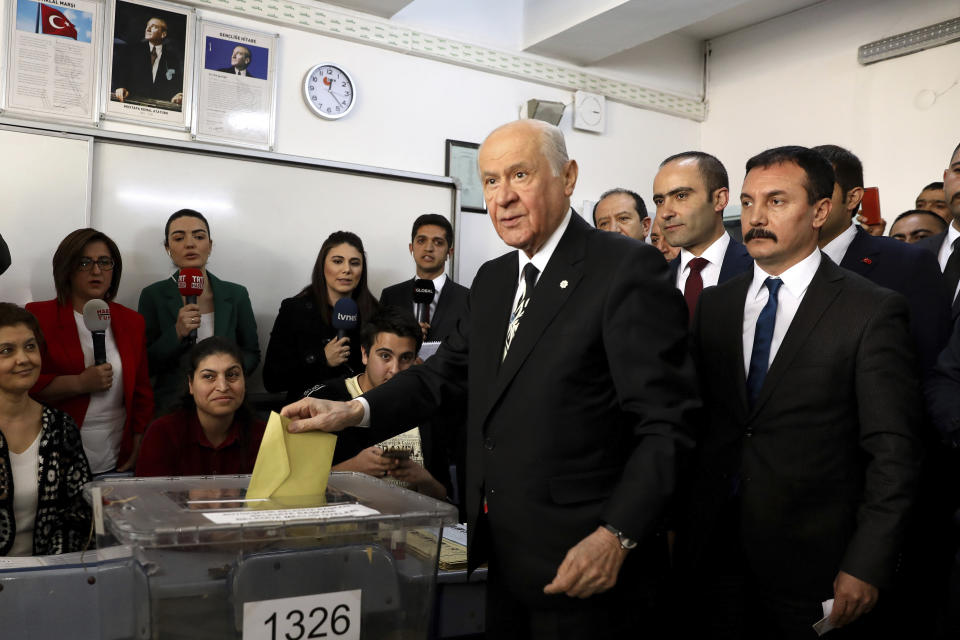 Chairman of the Nationalist Movement Party MHP Devlet Bahceli casts his ballot at a polling station in Ankara, Turkey, Sunday, March 31, 2019. Turkish citizens have begun casting votes in municipal elections for mayors, local assembly representatives and neighborhood or village administrators that are seen as a barometer of Erdogan's popularity amid a sharp economic downturn. (AP Photo/Ali Unal)