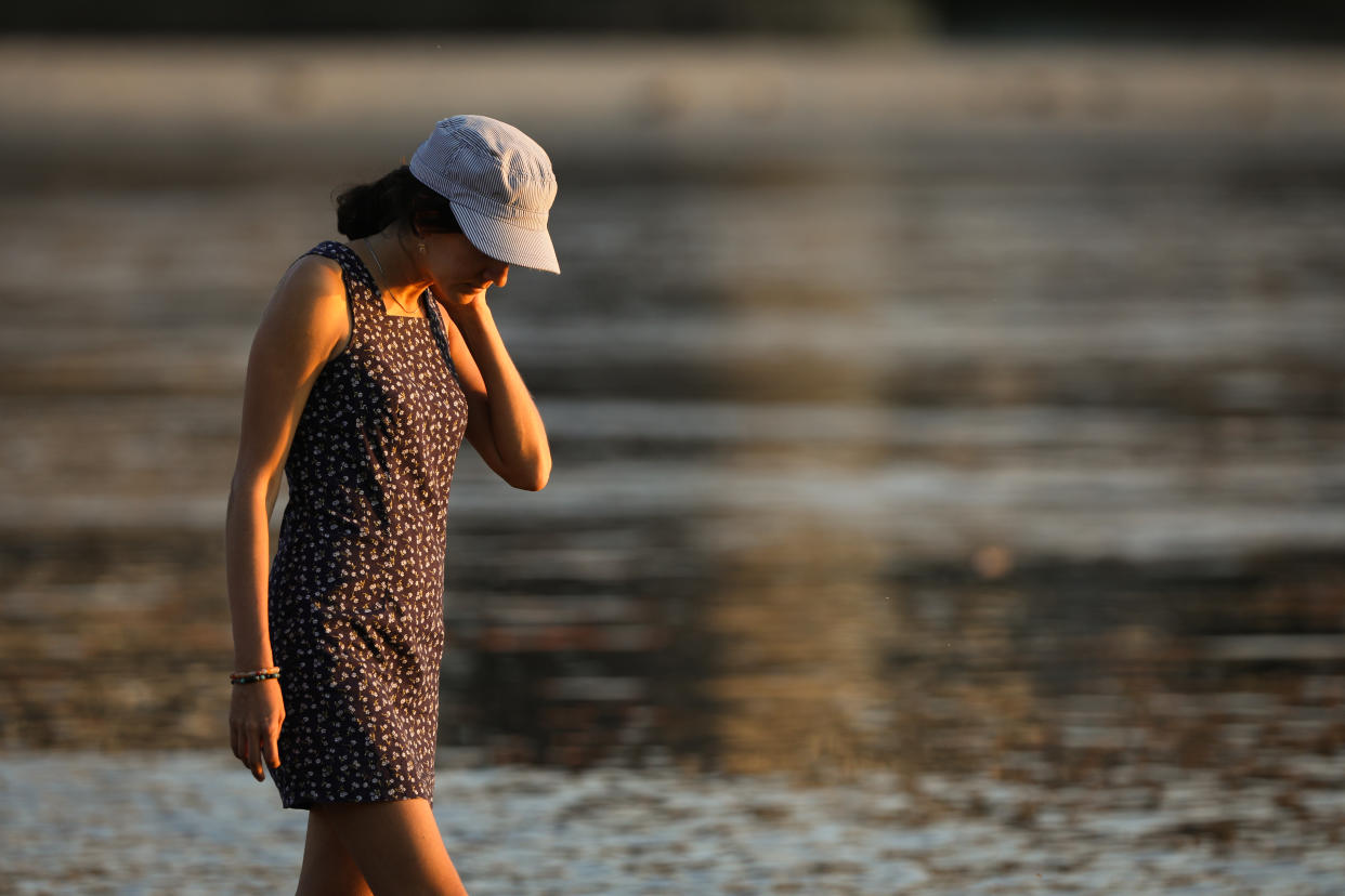 People are seen enjoying the warm weather at at a beach on the Vistula river in Warsaw, Poland on July 6, 2021. After a week of sharply rising and falling temperatures Poland is expected to see another heatwave with the mercury forecast to rise to a sweltering 35 degrees Celsius. (Photo by STR/NurPhoto via Getty Images)