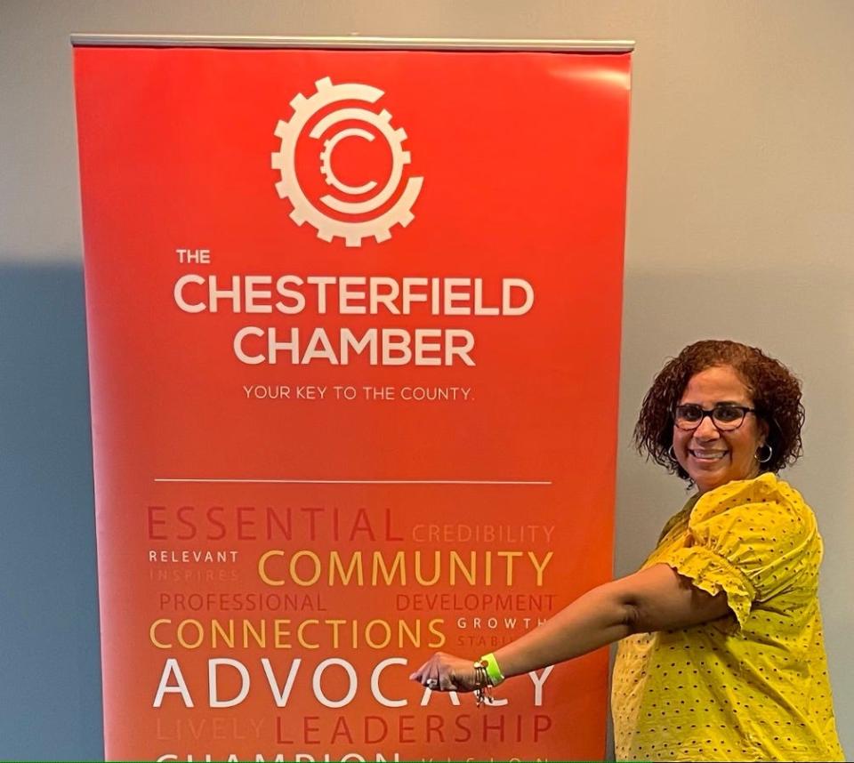 Danielle Fitz-Hugh, president of the Chesterfield Chamber of Commerce in Virginia, shows off one of the green wrist bands meeting attendees often wear to indicate they are vaccinated and open for handshakes.