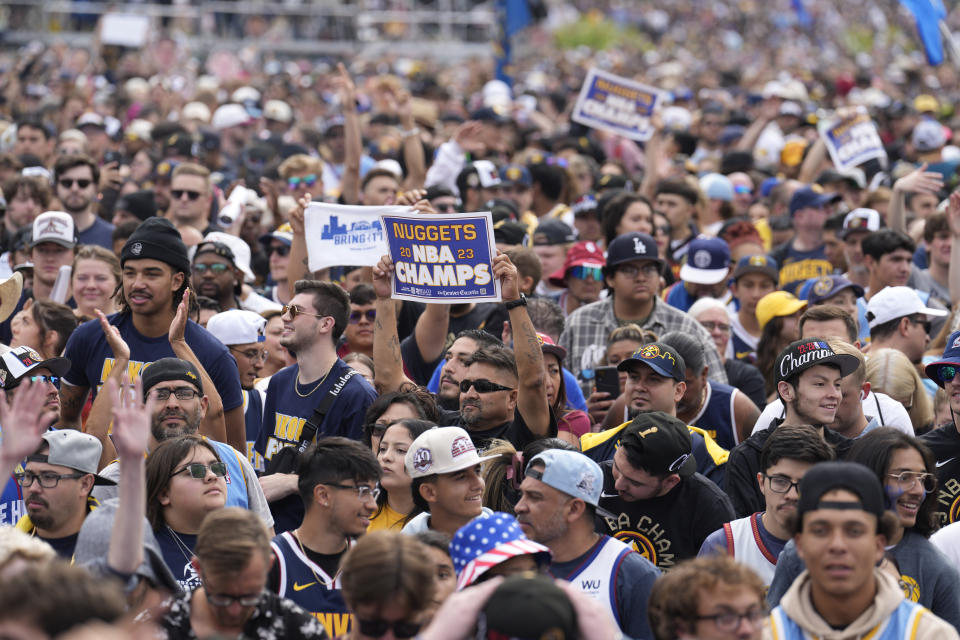 Fans cheer during a rally and parade to mark the Denver Nuggets first NBA basketball championship on Thursday, June 15, 2023, in Denver. (AP Photo/David Zalubowski)