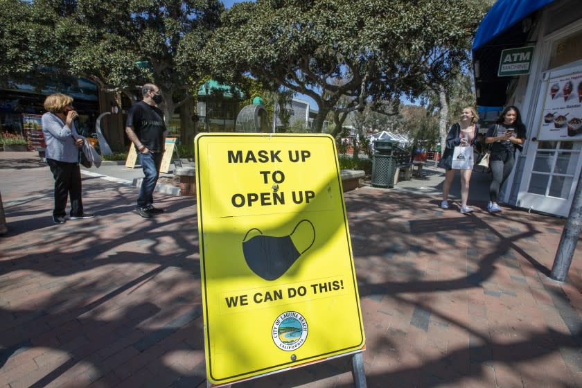 LAGUNA BEACH, CA - March 30: Pedestrians walk along the Promenade on Forest Ave, a pedestrian-only experience featuring shopping and restaurants, in Laguna Beach Tuesday, March 30, 2021. Orange County is moving into the state's less-restrictive orange tier as COVID-19 cases continue a downward trend and a windfall of vaccines rolls in. ``The numbers look good, and -- barring anything unforeseen -- we expect (Tuesday) to be on the orange tier list,'' Orange County CEO Frank Kim said. The state updates its weekly averages on Tuesdays based on statistics reported as of Sunday -- so if the numbers county officials have are accurate, the county could qualify for the orange tier on Tuesday and officially move into it on Wednesday. (Allen J. Schaben / Los Angeles Times)