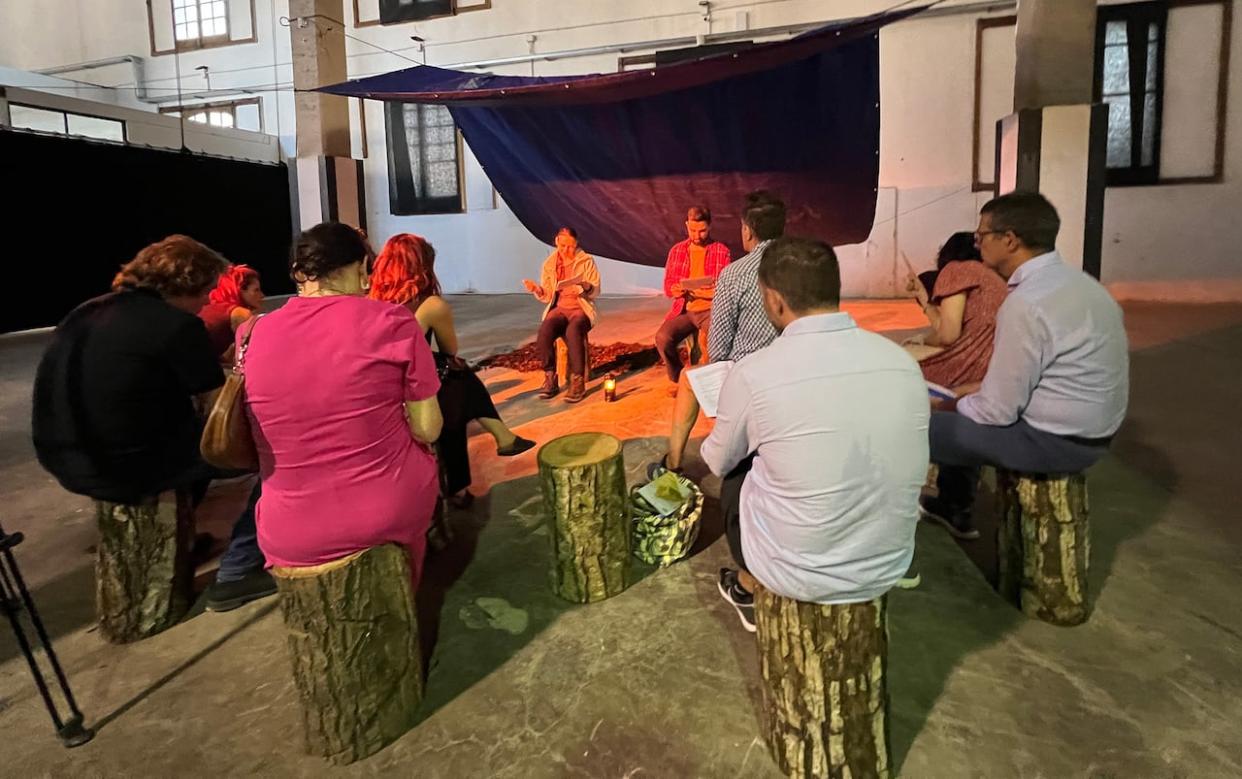 An audience in the Italian city of Paestum watches a performance of the VR-enhanced play Animate by director Chris Salter. (Megan Williams/CBC - image credit)