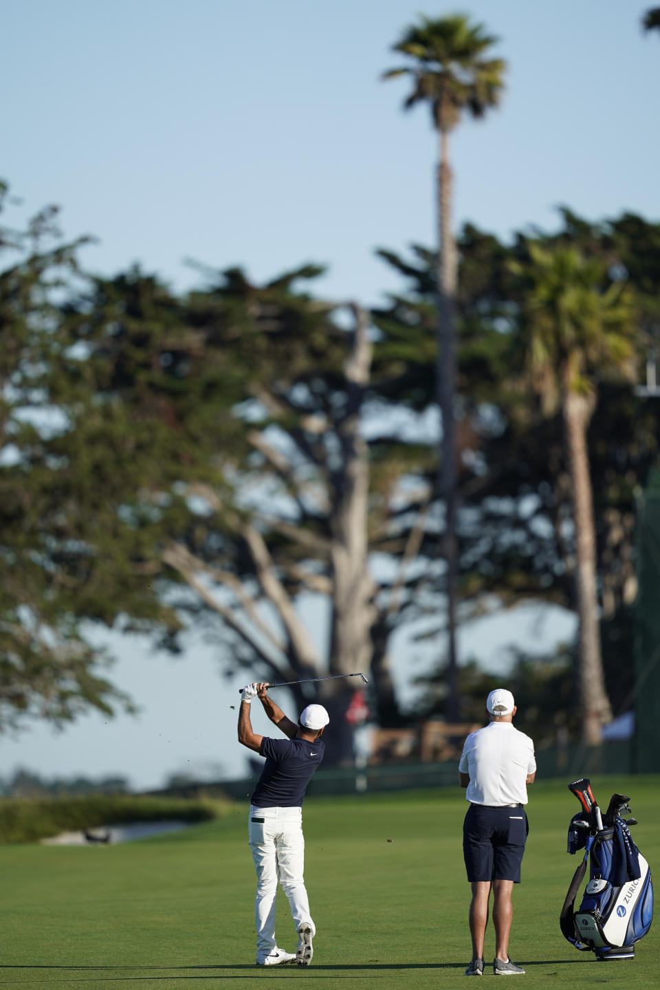 Jason Day, left, of Australia, hits from the fairway as caddie Steve Williams watches on the 13th hole during a practice round for the U.S. Open Championship golf tournament Tuesday, June 11, 2019, in Pebble Beach, Calif. (AP Photo/David J. Phillip)