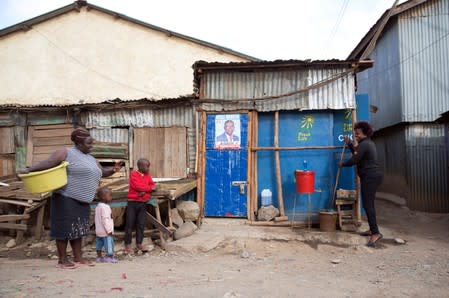 Lilian Mbusia rinses her mop outside a Fresh Life toilet, a franchise of toilets by Sanergy, which charges the residents of Mukura Kwa Ruben slum in Nairobi