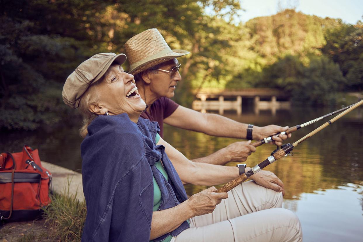 senior couple enjoying on the lake fishing and having fun