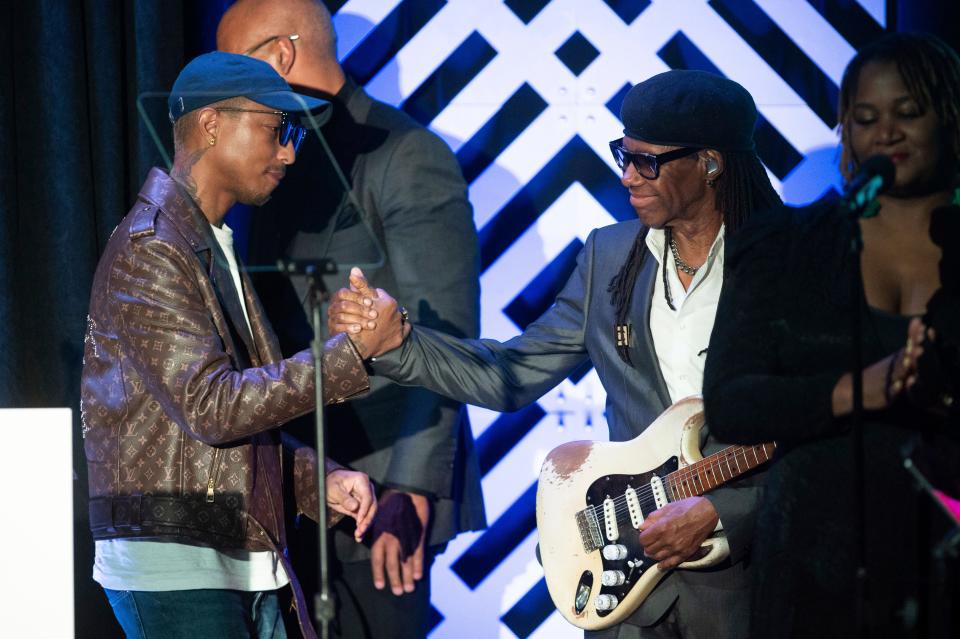 Pharrell Williams is congratulated by Nile Rodgers during the GRAMMYs on the Hill Awards April 26, 2023, at The Hamilton in Washington.