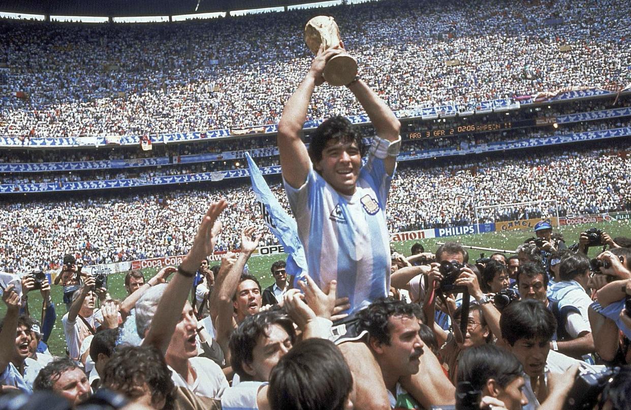 In this June 29, 1986 file photo, Diego Maradona holds up his team's trophy after Argentina's 3-2 victory over West Germany at the World Cup final soccer match at Azteca Stadium in Mexico City. The Argentine soccer great who was among the best players ever and who led his country to the 1986 World Cup title before later struggling with cocaine use and obesity, died from a heart attack on Wednesday, Nov. 25, 2020, at his home in Buenos Aires. He was 60.
