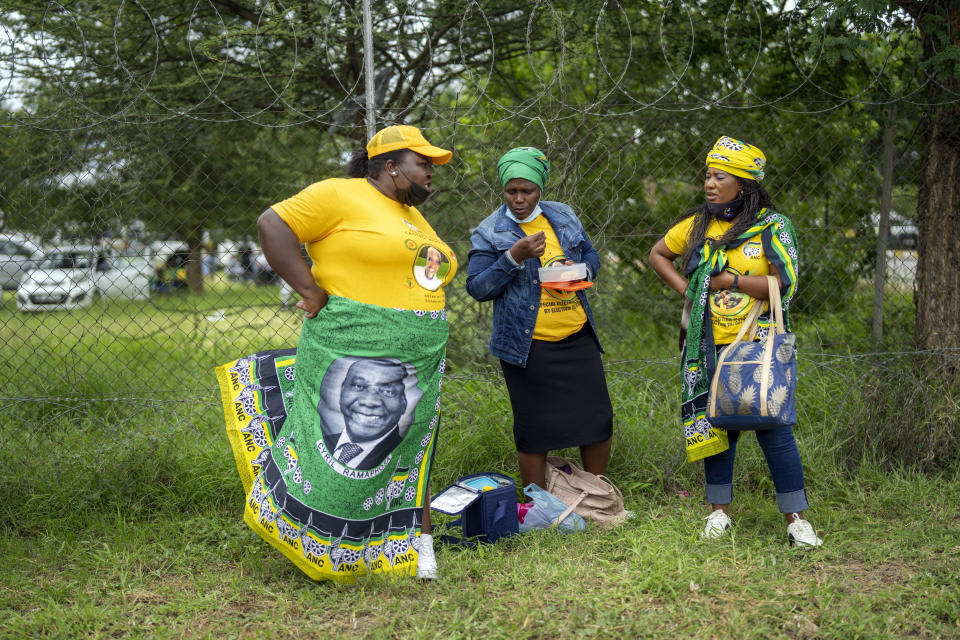 African National Congress party (ANC) supporters who could not access the party's 110th birthday celebration at Polokwane's Peter Mokaba stadium, stand outside the gate, in Polokwane, South Africa, Saturday Jan. 8, 2022. Because of coronavirus regulations, only 2000 could attend the anniversary , amid deep divisions, graft allegations and broad challenges that saw the ANC perform dismally in local government elections last year. ( (AP Photo/Jerome Delay)