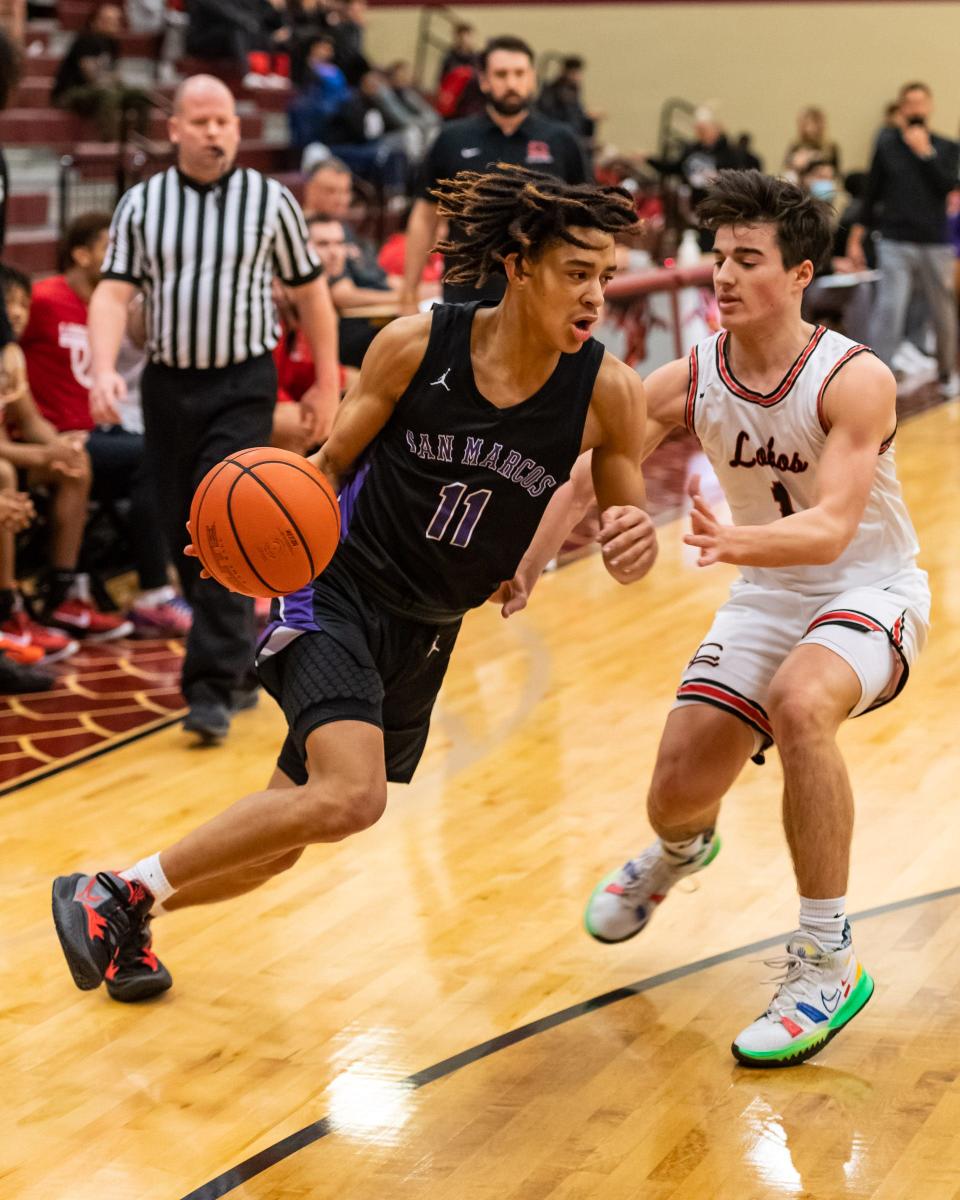 Kaden Gumbs drives of San Marcos drives against Langham Creek's Joey Clavin in tournament action earlier this season. Gumbs led the Austin area in assists with 5.9 a game this season.
