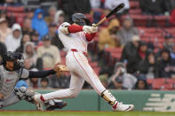 Boston Red Sox's Jarren Duran hits a two-run triple in front of Cleveland Guardians' Bo Naylor, left, in the sixth inning of a baseball game, Thursday, April 18, 2024, in Boston. (AP Photo/Steven Senne)