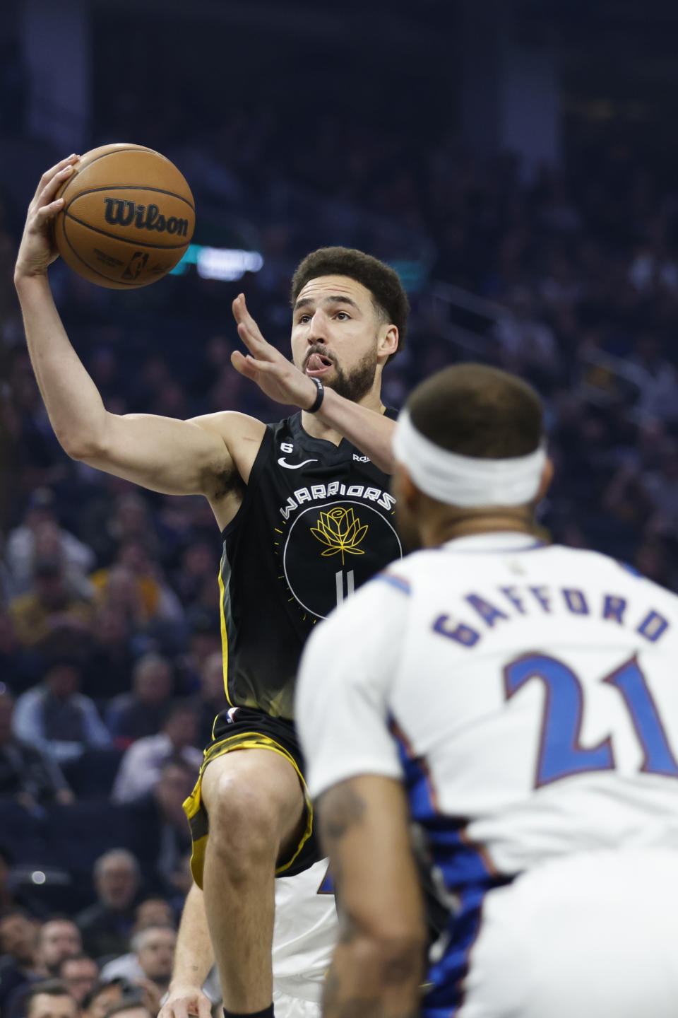 Golden State Warriors guard Klay Thompson (11) shoots over Washington Wizards center Daniel Gafford (21) during the first half of an NBA basketball game in San Francisco, Monday, Feb. 13, 2023. (AP Photo/Jed Jacobsohn)