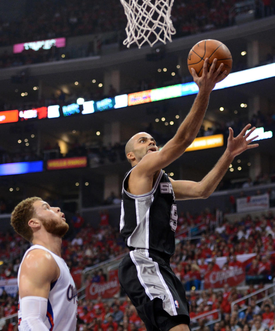 LOS ANGELES, CA - MAY 20: Tony Parker #9 of the San Antonio Spurs lays the ball up in front of Blake Griffin #32 of the Los Angeles Clippers in the first quarter in Game Four of the Western Conference Semifinals in the 2012 NBA Playoffs on May 20, 2011 at Staples Center in Los Angeles, California. NOTE TO USER: User expressly acknowledges and agrees that, by downloading and or using this photograph, User is consenting to the terms and conditions of the Getty Images License Agreement. (Photo by Harry How/Getty Images)