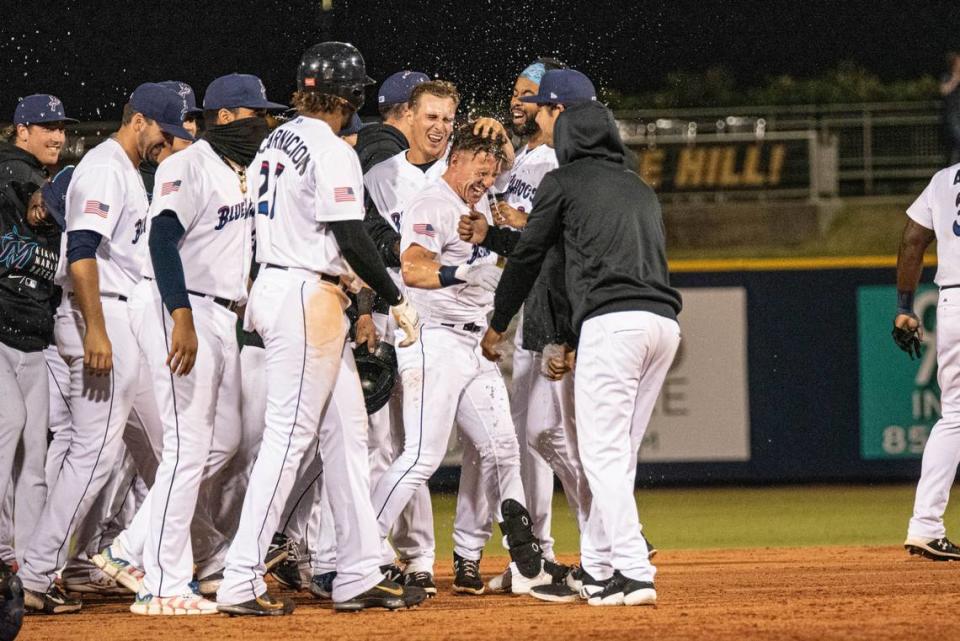 The Pensacola Blue Wahoos celebrate after Peyton Burdick hits a walk-off double in the 10th inning against the Rocket City Trash Pandas on Tuesday, May 18, 2021.