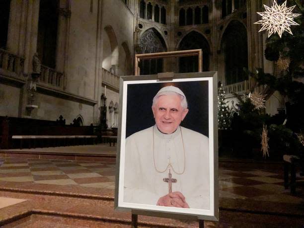 A portrait of Pope Emeritus Benedict XVI is seen near the altar at the Cathedral of Regensburg, southern Germany on 29 December 2022, during a church service (AFP via Getty Images)