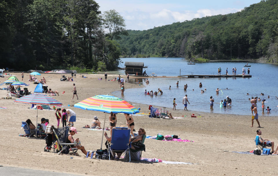 Beach goers enjoy the sand and the water at Canopus Lake at Fahnestock State Park in Carmel, June 20, 2021.