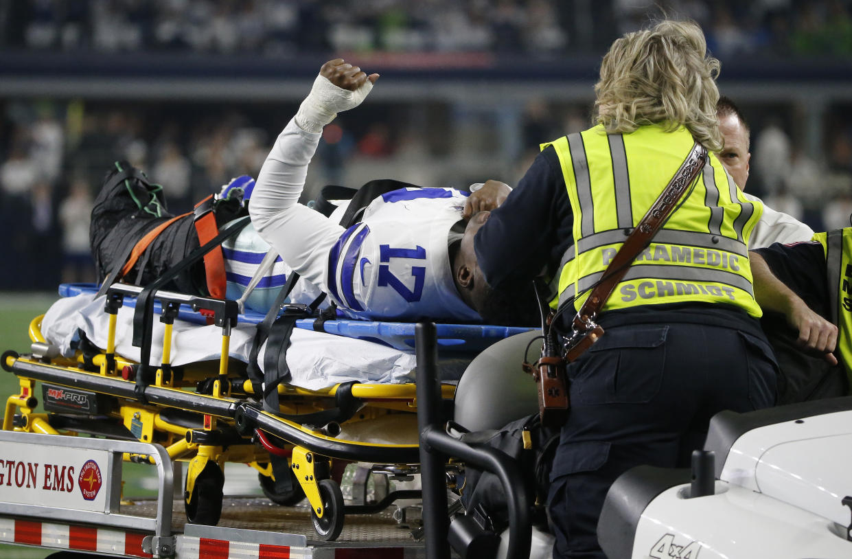 Dallas Cowboys wide receiver Allen Hurns (17) is taken from the field after injuring his leg against the Seahawks. (AP)