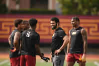Southern California quarterback Caleb Williams, second from right, speaks with, from right, Brenden Rice, Tahj Washington, and MarShawn Lloyd, during the during an NCAA college football team's NFL Pro Day, Wednesday, March 20, 2024, in Los Angeles. (AP Photo/Ryan Sun)