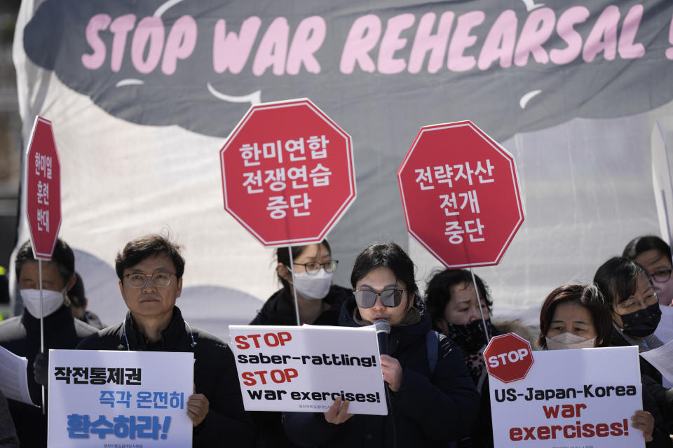 Protesters hold signs during a rally to oppose the planned joint military exercises between the U.S. and South Korea in Seoul, South Korea, Monday, March 13, 2023. The South Korean and U.S. militaries launched their biggest joint military exercises in years Monday, as North Korea said it conducted submarine-launched cruise missile tests in apparent protest of the drills it views as an invasion rehearsal. The letters read "Stop, the joint war exercises between the U.S. and South Korea." (AP Photo/Lee Jin-man)