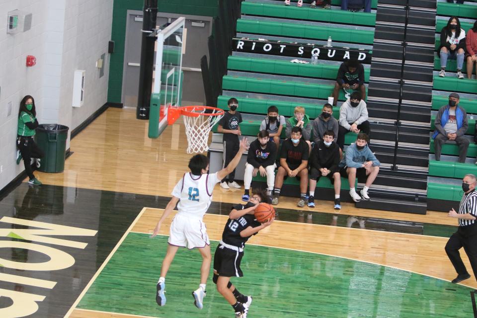 Navajo Prep's Jakobie Thomas attempts to get a shot over Shiprock's Jalen Wero during a third round game of the Marv Sanders Invitational Tournament, Saturday, Dec. 18, 2021 in the Scorpion Arena at Farmington High School.