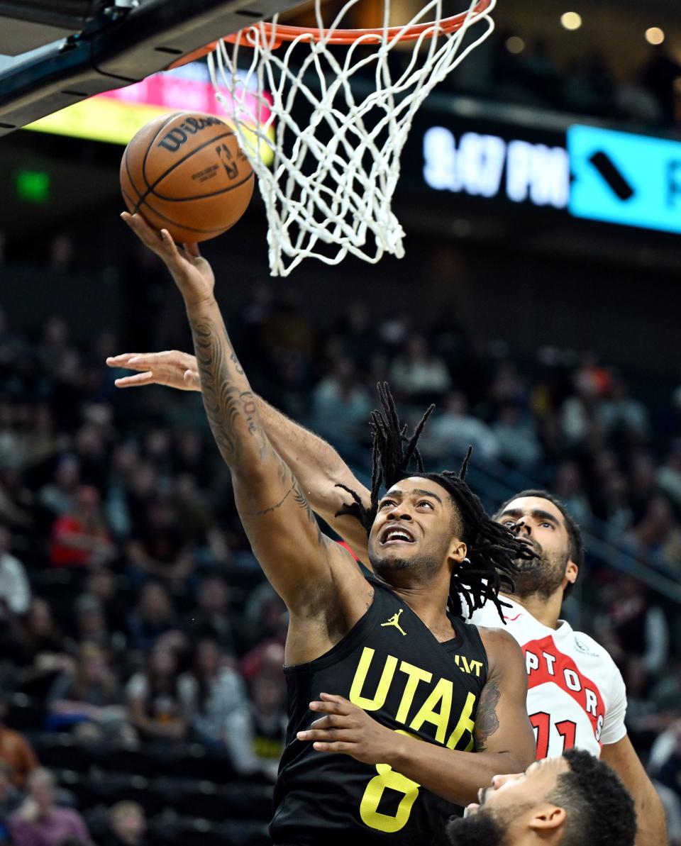 Utah Jazz forward <a class="link " href="https://sports.yahoo.com/nba/players/10122" data-i13n="sec:content-canvas;subsec:anchor_text;elm:context_link" data-ylk="slk:Brice Sensabaugh;sec:content-canvas;subsec:anchor_text;elm:context_link;itc:0">Brice Sensabaugh</a> (8) puts up a layup ahead of Toronto Raptors center Jontay Porter (11) as the Jazz and Raptors play at the Delta Center in Salt Lake City on Friday, Jan. 12, 2024. Utah won 145-113. | Scott G Winterton, Deseret News