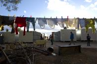 Washing is hung out to dry at the Ritsona refugee camp, about 86 kilometers (53 miles) north of Athens, Thursday, Jan. 5, 2017. Over 62,000 refugees and migrants are stranded in Greece after a series of Balkan border closures and an European Union deal with Turkey to stop migrant flows. (AP Photo/Muhammed Muheisen)