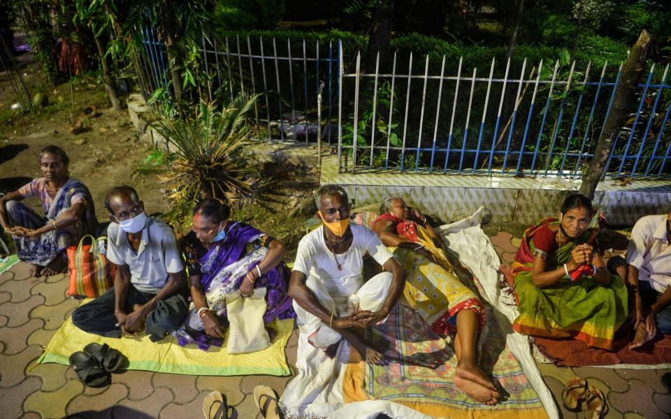 People camp overnight to get a Covid-19 vaccine at the government run district hospital in Siliguri, India on 20 September 2021 - Diptendu Dutta/AFP