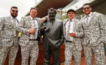 <p>Colourful punters pose for a snap with the great Bart Cummings.</p>