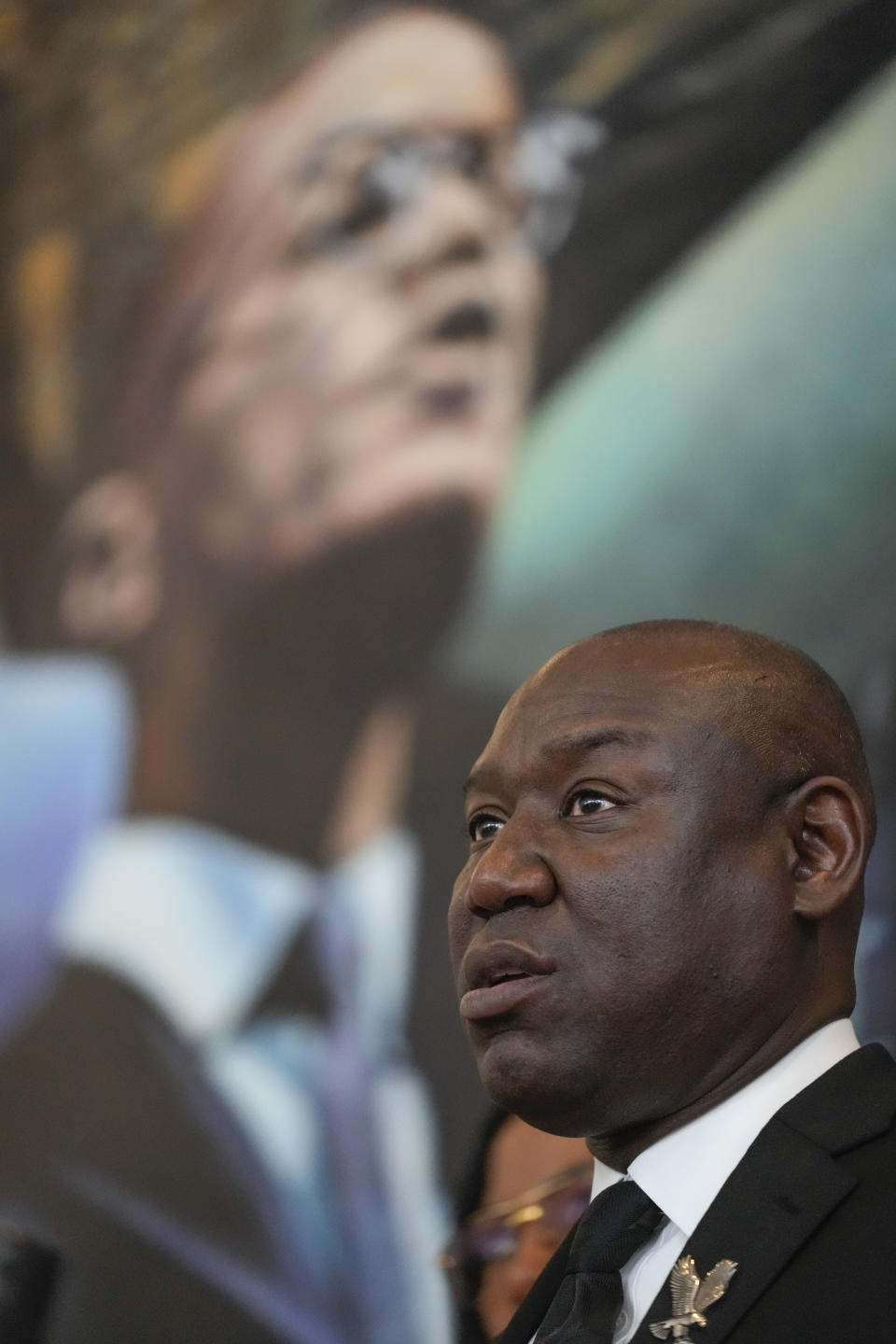 Attorney Ben Crump speaks in front of a mural of Malcolm X during a news conference at the Malcolm X & Dr. Betty Shabazz Memorial and Educational Center in New York, Tuesday, Feb. 21, 2023. Some of Malcom X's family members and their attorneys announced their intent to sue governmental agencies for Malcom X's assassination and the fraudulent concealment of evidence surrounding the murder. In 1965, the minister and civil rights activist was shot to death inside Harlem's Audubon Ballroom in New York. (AP Photo/Seth Wenig)