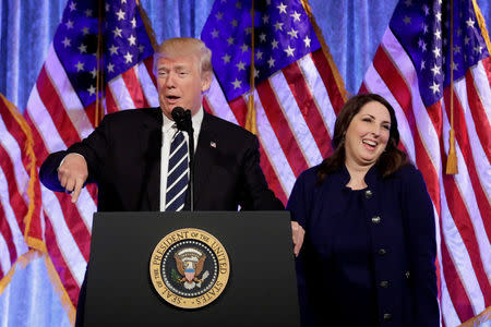 FILE PHOTO: RNC chairwoman Ronna McDaniel reacts next to U.S. President Donald Trump at a fundraising event in New York, U.S., December 2, 2017. REUTERS/Yuri Gripas/File Photo