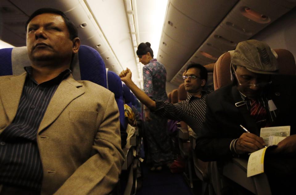 Passengers rest in their seats onboard Malaysia Airlines Boeing 777-200ER flight MH318 shortly after take off on route to Beijing